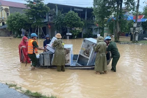 Lực lượng chức năng huyện Quỳ Châu giúp dân di chuyển tài sản đến nơi an toàn. (Ảnh: Quỳ Châu)