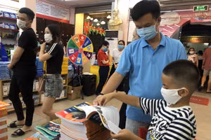 Phụ huynh, học sinh tìm mua sách tại các nhà sách phục vụ cho năm học mới. Ảnh minh hoạ P.Nga