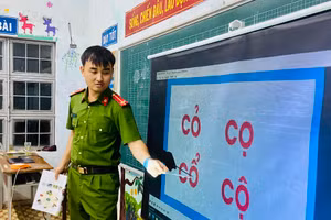 Trung úy Lê Tuấn Thành dạy chữ cho bà con làng Kret Krot.