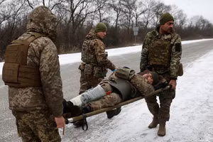 Nhân viên y tế của Quân đội Ukraine sơ tán một binh sĩ bị thương trên con đường không xa Soledar, vùng Donetsk. (Ảnh: Anatolii Stepanov / AFP