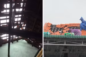 Người dân đang cố gắng lợp lại mái nhà trước khi bão số 5 đổ bộ.