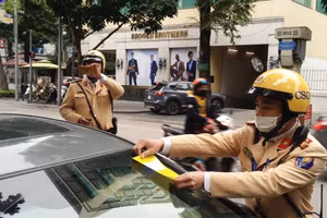 Lực lượng CSGT dán phạt nguội lái xe vi phạm.