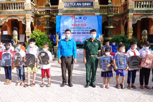 Đại tá Lê Văn Anh, Phó chính uỷ bộ đội Biên phòng Sóc Trăng và đồng chí Lê Minh Dương, Phó Bí thư Tỉnh đoàn Sóc Trăng trao tặng cặp da cho học sinh có hoàn cảnh khó khăn.