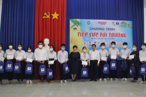 Nhà báo Dương Thanh Hương - Phó tổng Biên tập Báo GD&TĐ và ông Phạm Ngọc Hải, Giám đốc Sở GD&ĐT Tây Ninh tặng học bổng cho các em học sinh nghèo vượt khó.