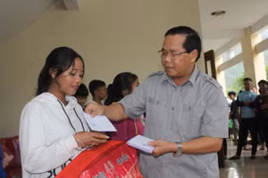 Đại diện UBND huyện Tây Giang trao quà hỗ trợ cho HS Trường THPT Võ Chí Công (huyện Tây Giang) sớm ổn định để học tập ở địa điểm mới. 