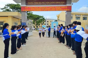 Tình nguyên viên chào đón thí sinh ở điểm thi Trường THPT Dương Quang Đông (Cầu Ngang, Trà Vinh).