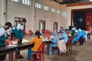 Học sinh tại một điểm trường THPT ở Quảng Trị khám sàng lọc trước khi tiêm vắc xin Covid-19.