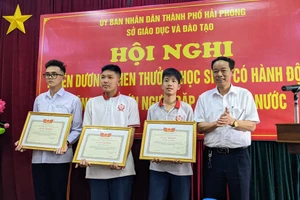 Ông Phạm Quốc Hiệu- Phó Giám đốc Sở GD&ĐT Hải Phòng tặng Bằng khen cho em Đỗ Đình Phúc, Đỗ Văn Sơn và Vũ Hữu Nam.