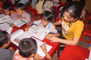 Học sinh ở bán trú tại Trường Tiểu học Huồi Tụ 2 (huyện Kỳ Sơn, Nghệ An) được thầy cô phụ đạo kiến thức buổi tối.