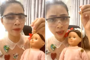 Hình ảnh Thơ Nguyễn ôm búp bê trong clip xin vía học giỏi cho các em học sinh.