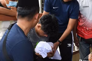 Syafiq Ahmad đau đớn bế cậu con trai 22 ngày tuổi đã qua đời. 