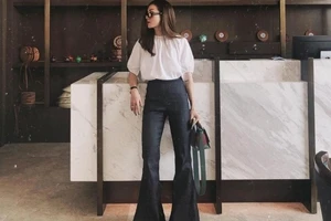 Yến Nhi “đổi gió” phong cách văn phòng với áo blouse trắng tay bồng và quần ống loe cạp cao.