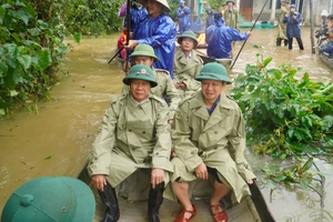 Phó Thủ tướng Lê Văn Thành (bên trái) cùng lãnh đạo tỉnh Thừa Thiên - Huế đi ghe vào vùng "rốn lũ" thăm hỏi và tặng quà người dân gặp khó khăn do thiên tai gây ra.