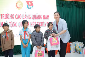 PGS.TS Vũ Thị Phương Anh - Hiệu trưởng Trường Cao đẳng Quảng Nam trao quà cho các em học sinh có hoàn cảnh khó khăn. 