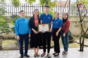 Đại diện huyện đoàn Diễn Châu, Nghệ An khen thưởng đột xuất cho em Cao Xuân Phát vì có hành động đẹp. Ảnh: NVCC