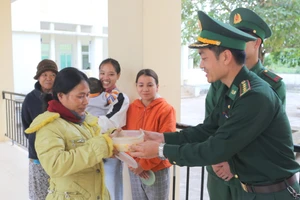 Đại úy Lê Anh Quốc, Bí thư Đoàn Đồn Biên phòng cửa khẩu quốc tế La Lay trao cháo cho bệnh nhân.