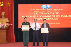 Đồng chí Trần Sâm (ngoài cùng bên phải) và đồng chí Vũ Minh được Thứ trưởng Phạm Ngọc Thưởng (ở giữa) trao Huy hiệu 30 năm tuổi Đảng