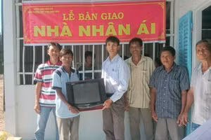 Thầy Nguyễn Ngọc Hân (áo trắng trao quà) trong một chuyến từ thiện. Ảnh: NVCC