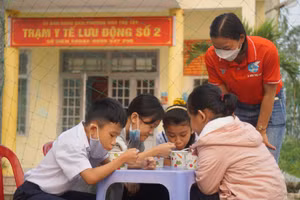 Những em học sinh thưởng thức những món ăn do chi hội phụ nữ nấu.