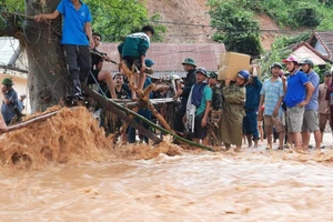 Lực lượng địa phương, thầy cô, người dân làm cầu tạm qua suối để đón gần 60 học sinh THPT Kỳ Sơn bị mắc kẹt trong bản Sơn Hà, xã Tà Cạ ra ở ký túc xá trong trường.