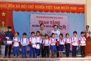 Lãnh đạo Sở GD&ĐT Quảng Trị và đại diện Câu lạc bộ phóng viên thường trú tại Quảng Trị trao học bổng đến các em học sinh. 
