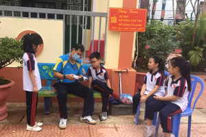 Thầy Toàn dán đế giày cho học sinh. Ảnh: NVCC