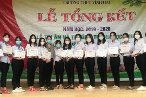 Huỳnh Thị Di Phụng (thứ ba từ trái sang) chụp ảnh lưu niệm với các bạn khi nhận giấy khen danh hiệu học sinh giỏi tại Trường THPT Vĩnh Hải.