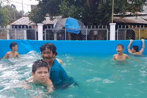 Bà Thia dạy bơi cho trẻ.