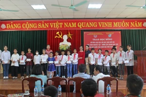 Gia đình tiến sĩ Lê Xuân Thảo, Lê Bích Thắng trao học bổng đỡ đầu cả năm cho 20 học sinh mồ côi, có hoàn cảnh khó khăn. Ảnh: LT.