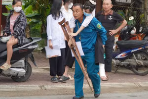 Thí sinh Nguyễn Thị Hồng Hạnh bị tai nạn gãy chân được bố cõng vào phòng thi.