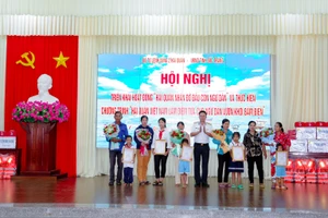 Trao quyết định nhận đỡ đầu học sinh nghèo.