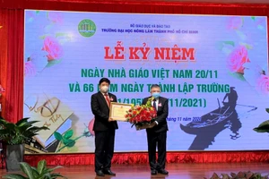  PGS.TS Huỳnh Thanh Hùng- Quyền hiệu trưởng Trường ĐH Nông Lâm trao tặng bằng khen của Bộ trưởng Bộ GD&ĐT cho TS Trần Đình Lý - Phó hiệu trưởng Nhà trường