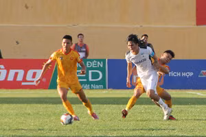 Cầu đội bóng Đông Á Thanh Hóa (áo vàng) trong một pha tranh bóng. Ảnh: Mạnh Cường