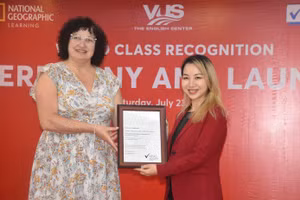 Đại diện NEAS trao chứng nhận cho đại diện VUS - Giám đốc điều hành Quách Nguyễn Kim Hằng (phải).