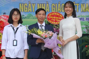 Thầy Nguyễn Duy Bỉnh nhận hoa chúc mừng nhân Ngày Nhà giáo Việt Nam.