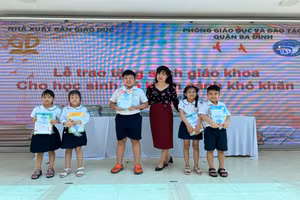 Cô Phạm Thị Thiên Nga - Hiệu trưởng trường Tiểu học Nguyễn Bá Ngọc cùng một số học sinh nhận sách giáo khoa mới.