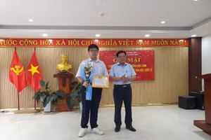 Ông Thái Viết Tường - Giám đốc Sở GD&ĐT tỉnh Quảng Nam tặng giấy khen vinh danh em Đỗ Phú Quốc. Ảnh: Sở GD&ĐT tỉnh Quảng Nam. 