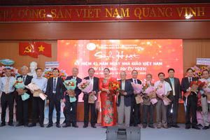 PGS.TS Vũ Thị Phương Anh (áo dài đỏ) - Hiệu trưởng Trường Cao đẳng Quảng Nam tặng hoa và quà tri ân các cựu giáo chức. 