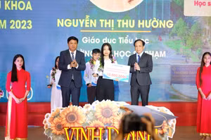 Ông Lương Nguyễn Minh Triết (thứ 2, trái sang) - Phó Bí thư Thường trực Thành ủy, Chủ tịch HĐND TP Đà Nẵng và PGS.TS Nguyễn Ngọc Vũ - Giám đốc Đại học Đà Nẵng tặng biểu trưng vinh danh và số tiền thưởng 10 triệu đồng cho các Thủ khoa. 