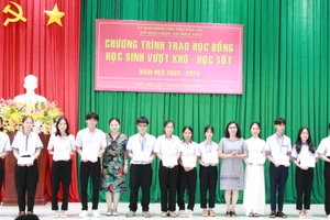 Ban tổ chức trao học bổng cho học sinh. (Ảnh: TT)