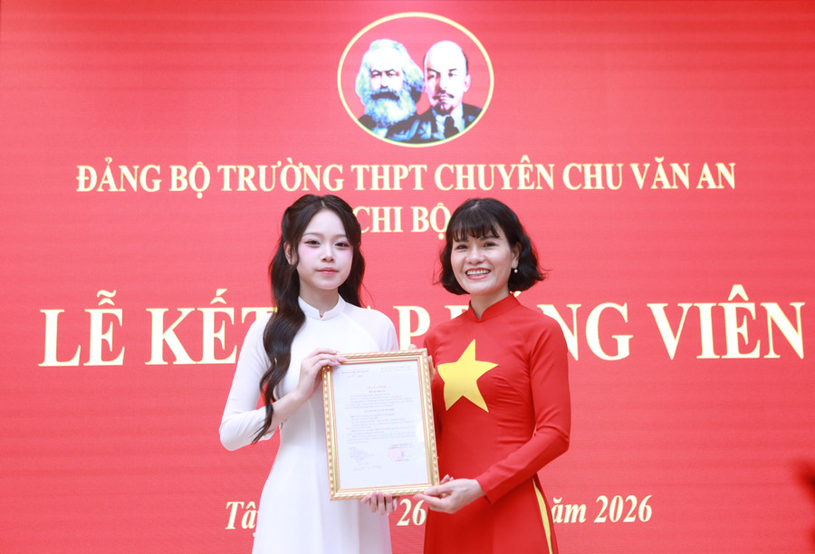 Nhà giáo Nguyễn Thị Nhiếp trao quyết định kết nạp Đảng cho Đảng viên mới.