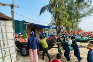 Lực lượng chức năng cùng người dân di chuyển tàu, thuyền đến khu vực an toàn.