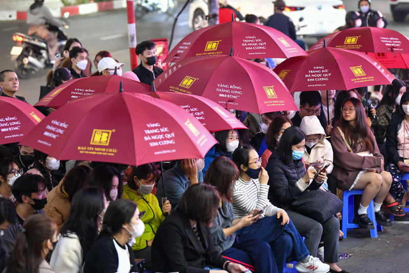 Người dân đội mưa, xếp hàng trong đêm chờ mua vàng ngày vía Thần Tài