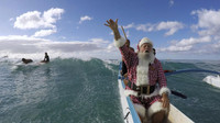 Santa Claus cưỡi thuyền thay vì tuần lộc trên bãi biển Waikiki, Honolulu, Hawaii (Ảnh: Hugh Gentry).