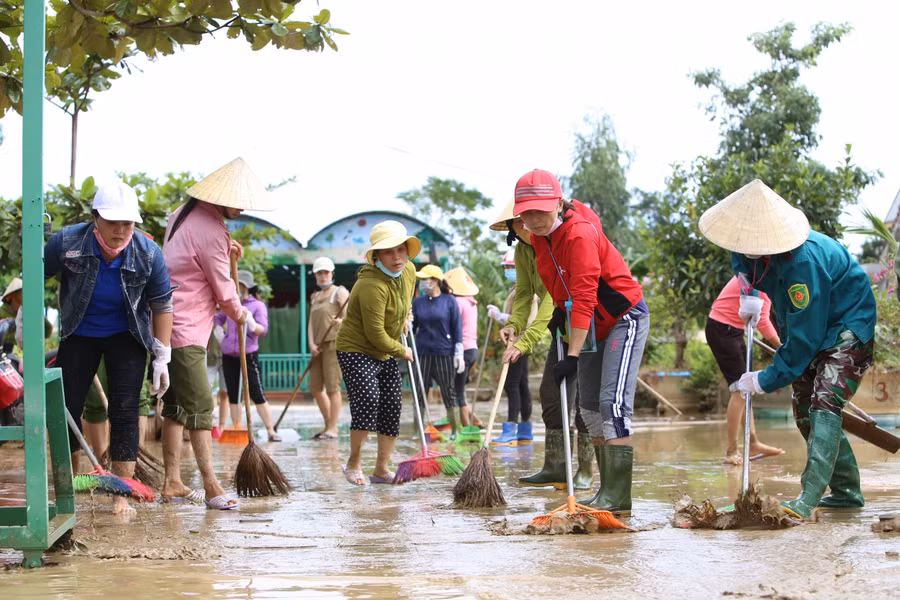 Giáo viên Trường mầm non Liên Thuỷ dọn bùn ra khỏi trường