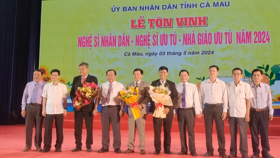 3 giáo viên (Người cầm hoa) chụp ảnh lưu niệm cùng lãnh đạo tỉnh.