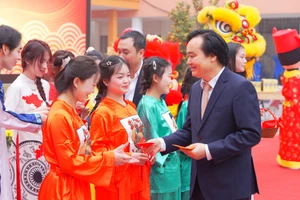 Nguyên Bộ trưởng Bộ GD&ĐT Phùng Xuân Nhạ tặng quà Tết cho sinh viên Trường CĐ Thương mại và Du lịch Hà Nội.