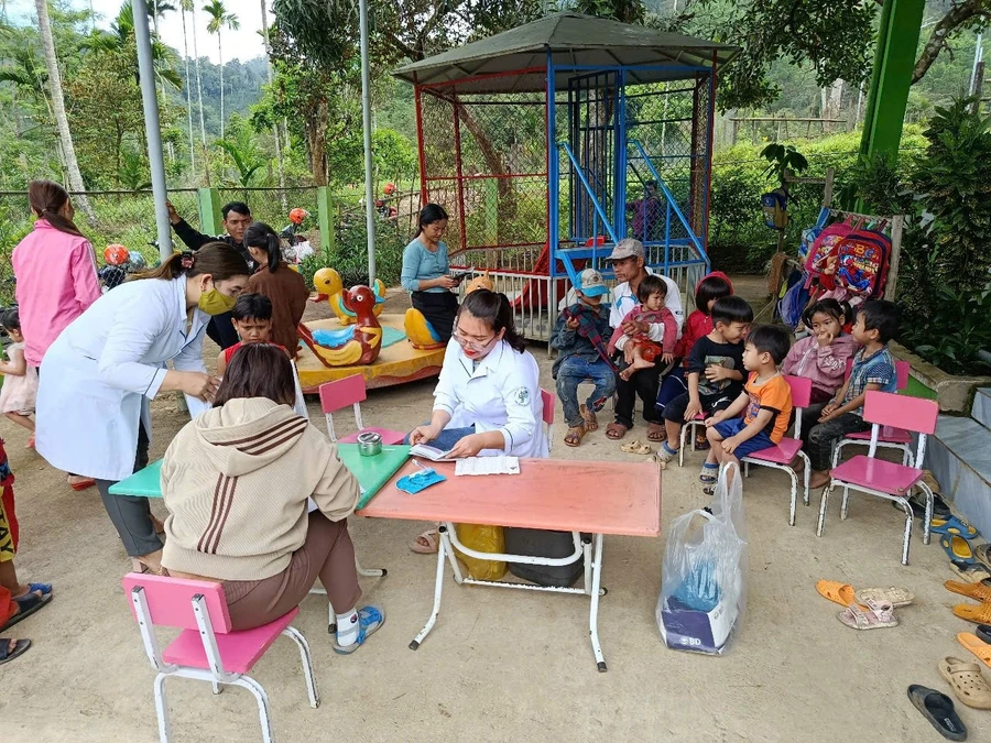 Đoàn công tác giám sát hỗ trợ hoạt động tiêm chủng tại một trường học ở Nam Trà My. Ảnh: CDC Quảng Nam