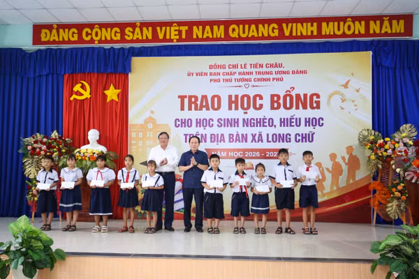 Ủy viên Ban Chấp hành Trung ương Đảng, Phó Thủ tướng Lê Tiến Châu và Chủ tịch UBND tỉnh Tây Ninh Lê Văn Hẳn trao học bổng cho học sinh. (Ảnh: BTN) 