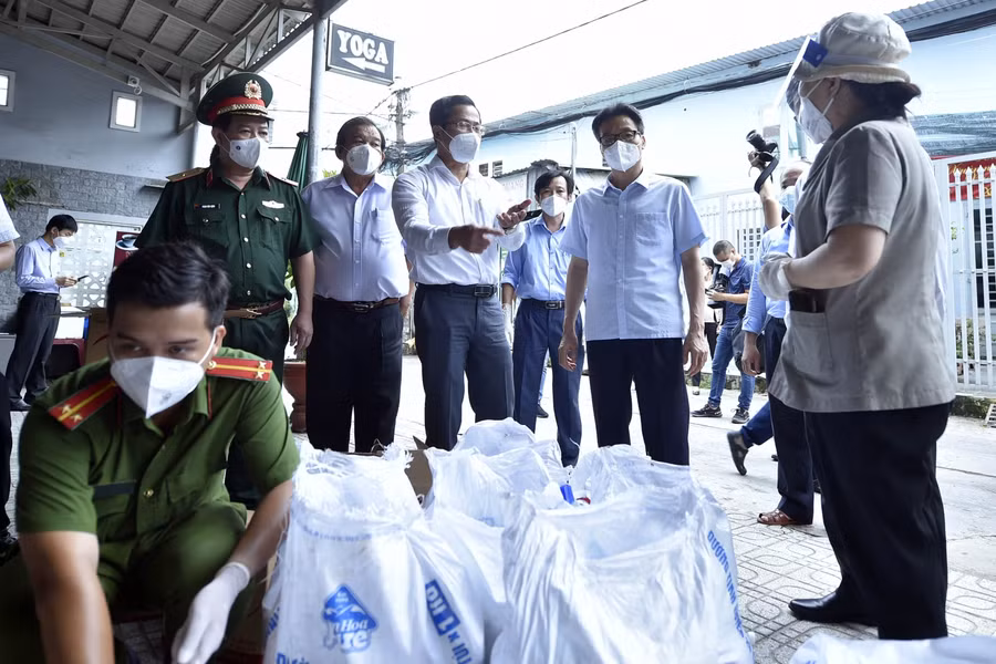 Phó Thủ tướng Vũ Đức Đam kiểm tra một điểm tiếp nhận, đóng gói túi an sinh tại Khu phố 6, Phường Tân Chánh Hiệp, Quận 12. Ảnh: VGP.